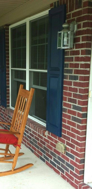 A navy color like Sherwin Williams In The Navy on window shutters.
