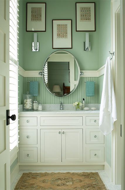 Benjamin Moore’s Budding Green keeps this bathroom nature-centered and pairs excellently with white accents
